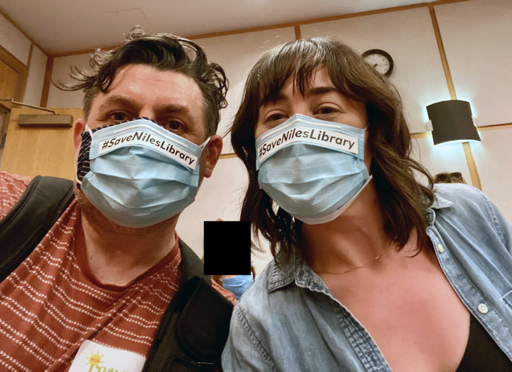 #SaveNilesLibrary Organizers taking a selfie wearing facemasks that read #save niles library.