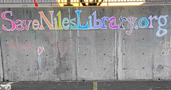 Chalk mural that reads "Save Niles Library"
